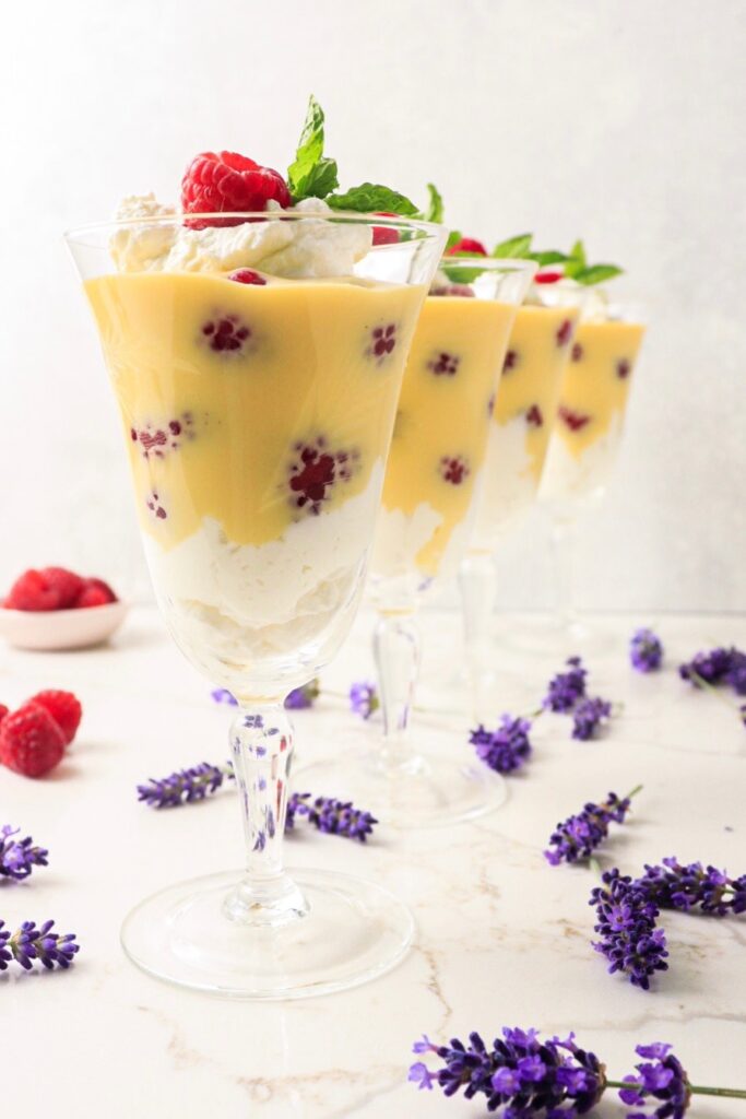 Four servings of raspberries with lavender cream